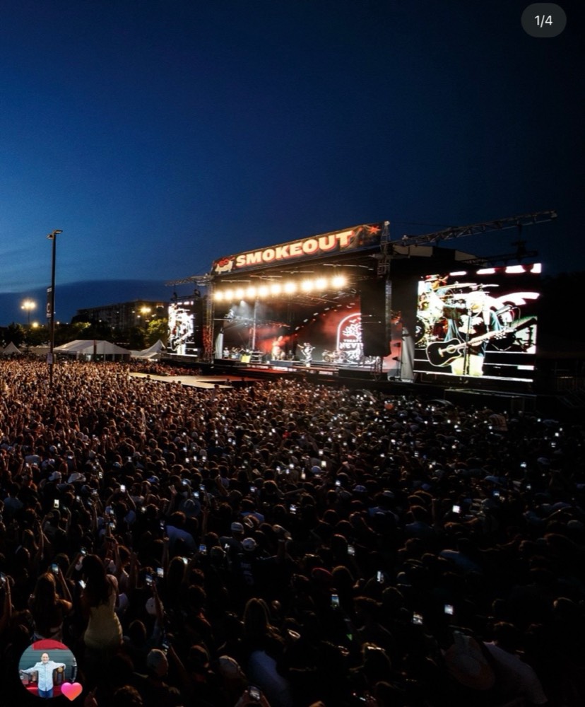Smokeout festival stage in front of a huge crowd at dusk